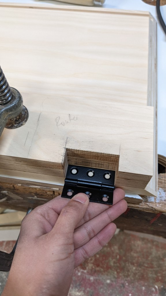 Routing pockets for the butt hinges with the help of a plywood jig
