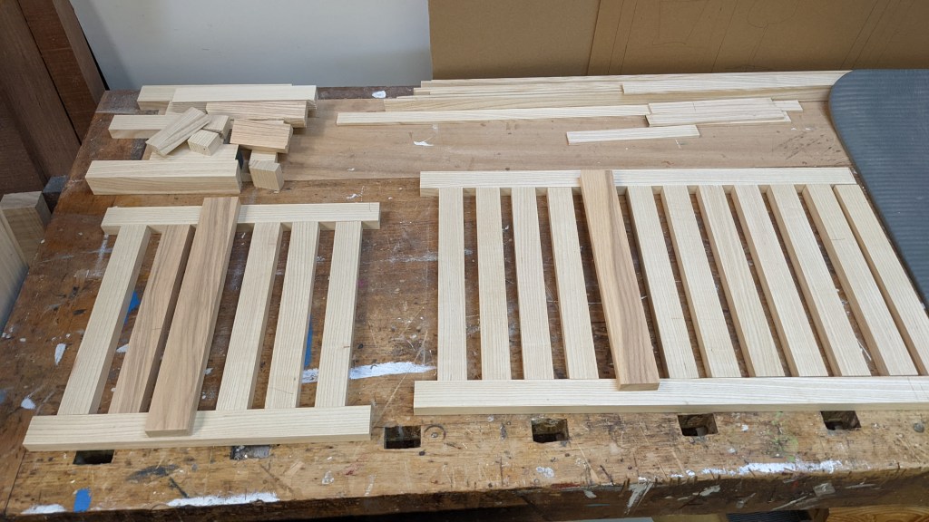 I made two slatted solid wood trays to sit between the legs of the cabinets