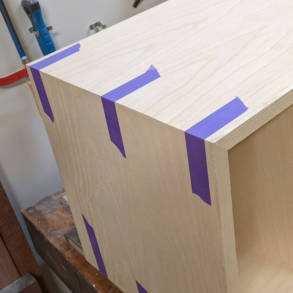 Mitred corners on cabinets showing a continuous waterfall woodgrain